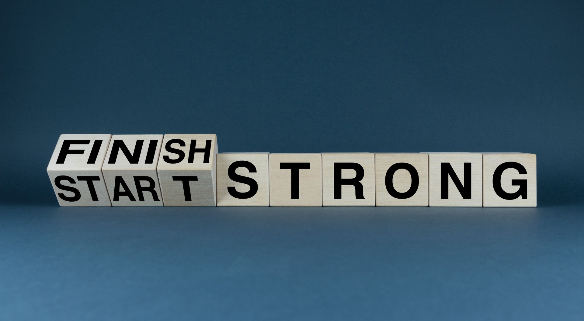 Start strong - Finish strong. The cubes form the words Start strong - Finish strong.